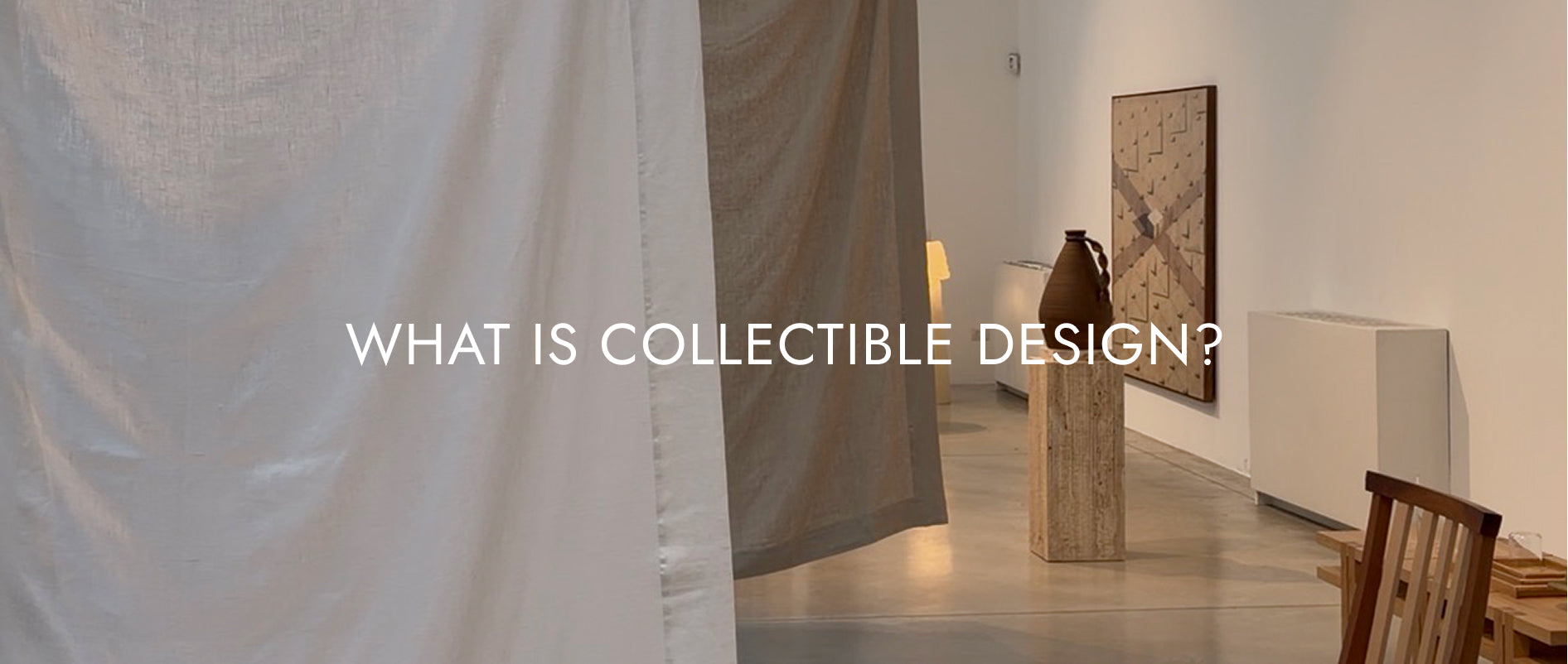 An interior of gallery in Milan with some pieces of furniture and linen partitions