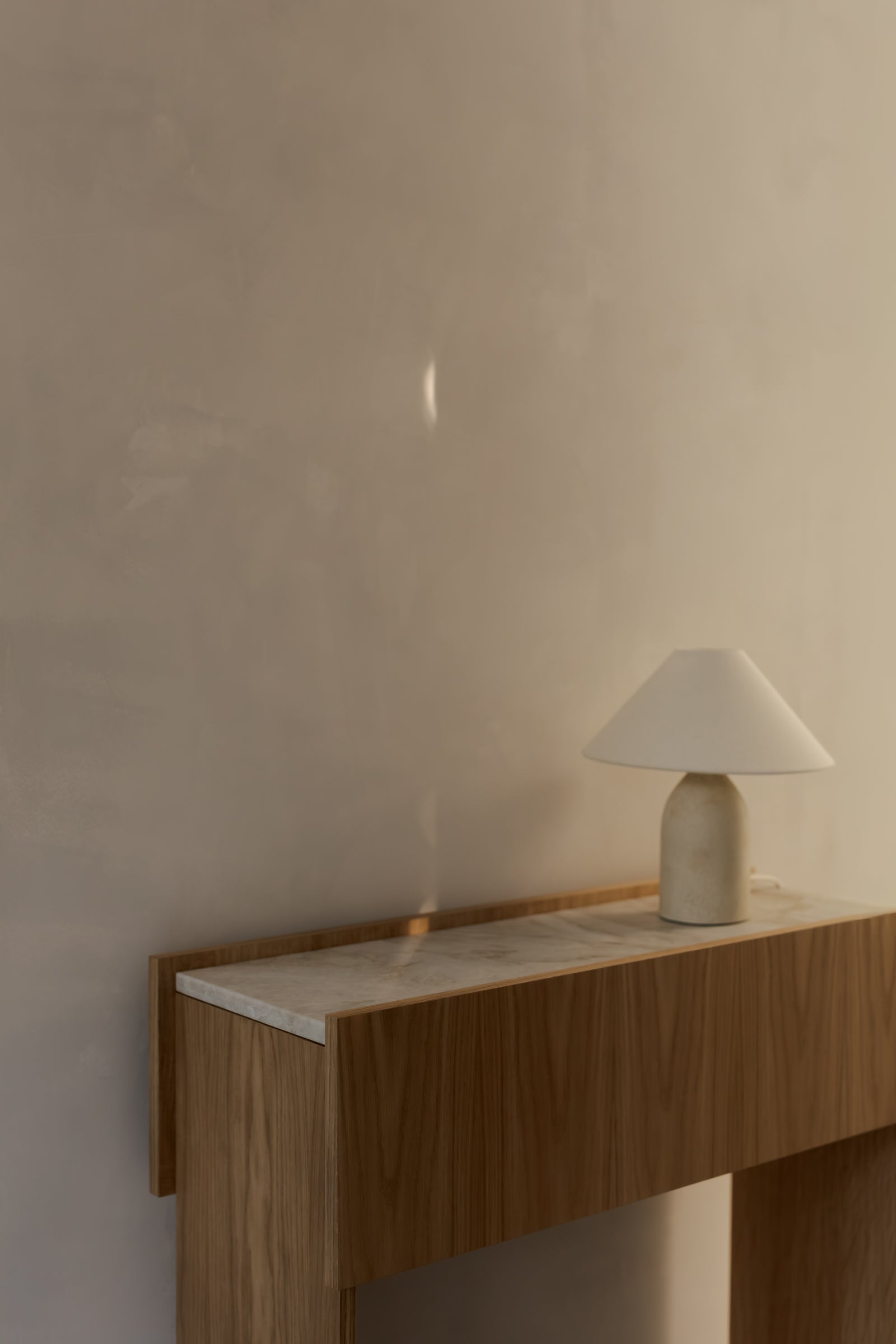 Close-up of a natural marble top resting on an oak console table.